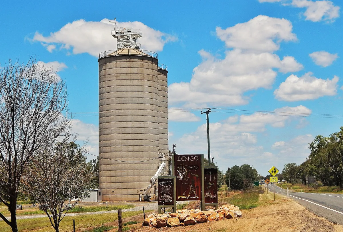 Silo de granos junto a la carretera, en Dingo, Australia. Un silo es un cilindro: para saber cuánto grano le cabe se mide el área del círculo del piso y se multiplica por la altura. Es la misma idea del prisma, área de la base por altura, con la base redonda. Imagen de Wikimedia Commons, RegionalQueenslander, licencia CC BY-SA 4.0.